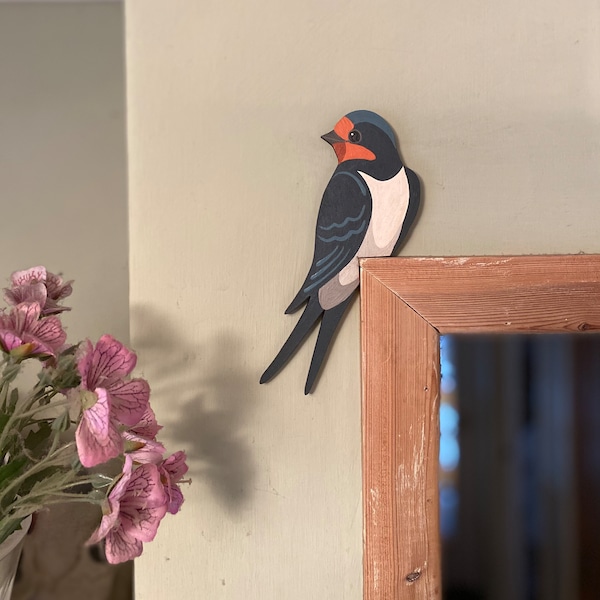 Hand painted swallow for sitting on a door frame.