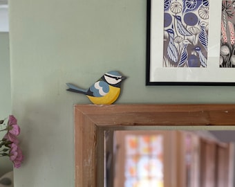 Hand painted blue tit for sitting on a door frame, picture rail or similar.
