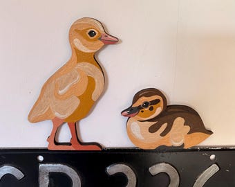 Hand painted duckling to sit on a door frame, picture rail etc.