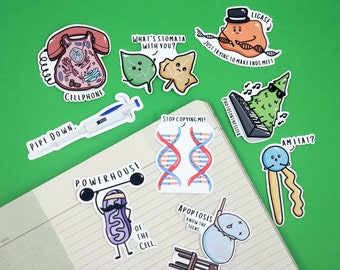 May include: A set of colorful stickers featuring various cell parts and processes. The stickers include a phone-shaped cell, a DNA double helix, a mitochondrion lifting weights, a plant cell with stomata, a ligase enzyme, a chloroplast playing a keyboard, and a lysosome with a noose around its neck.
