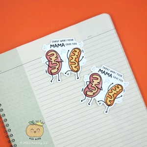 May include: Two cartoon stickers of mitochondria dancing with the text "Shake what your mama gave you". The mitochondria are pink and orange with little legs and arms. The stickers are on a lined notebook with a small pumpkin sticker with the text "Pun King" at the bottom.