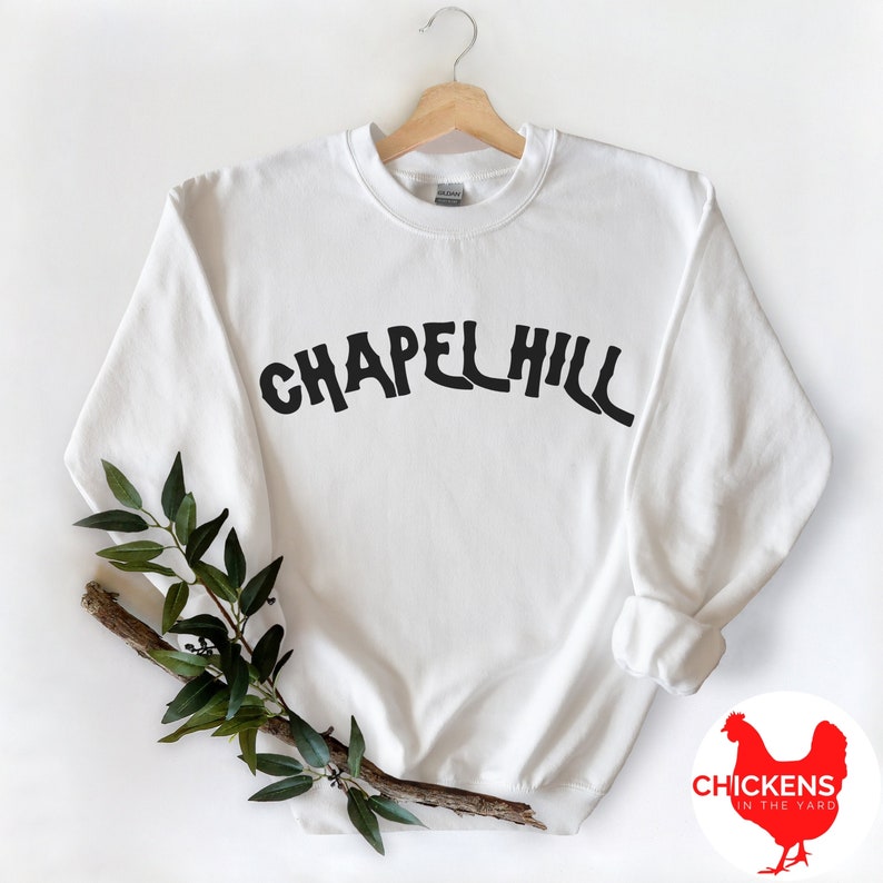 May include: White sweatshirt with black text that reads "Chapel Hill".