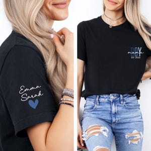 two women wearing black t-shirts with personalized text and designs.
