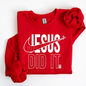 A red sweatshirt with the text "JESUS DID IT" printed on it.