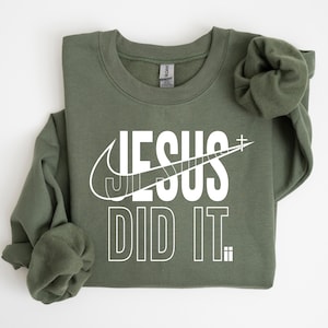 A green sweatshirt with the text "JESUS DID IT" printed on it.