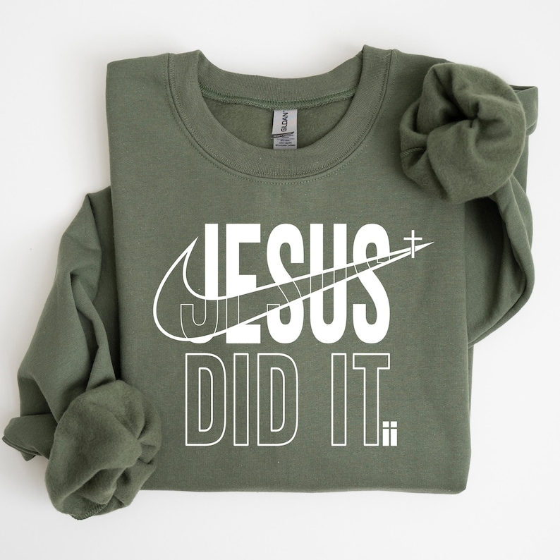 A green sweatshirt with the text "JESUS DID IT" printed on it.