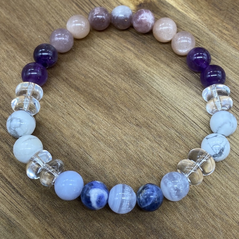 Anxiety-Insomnia Crystal Bracelet - Made with Genuine Sodalite, Blue Lace, Lepidolite, Amethyst, and Moonstone Crystals - All beads are Grade A+ and the bead size is 8mm - Crystal information cards are included - Handcrafted made and custom-made