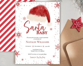 May include: A white baby shower invitation with a red and white striped envelope. The invitation features a watercolor illustration of a Santa hat and the text "Santa Baby". The invitation also includes the text "Please join us for a baby shower in honor of Natalie Williams" and the date and time of the shower.