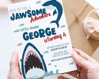 May include: A white birthday invitation with a blue shark graphic. The invitation says "Join us for a Jawsome Adventure, our little shark George is turning 4". The invitation also includes the date, time, and location of the party.