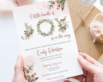 May include: A white baby shower invitation with a watercolour illustration of a wreath with the word "JOY" in red letters. The text "A little bundle of joy is on the way" is written in red letters. The invitation is for Emily Robertson's baby shower on 18th December 2021 at 4:00 PM.