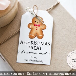 May include: A white gift tag with a gingerbread man illustration. The tag says "A Christmas Treat for someone sweet" and "From, The Wilson Family".