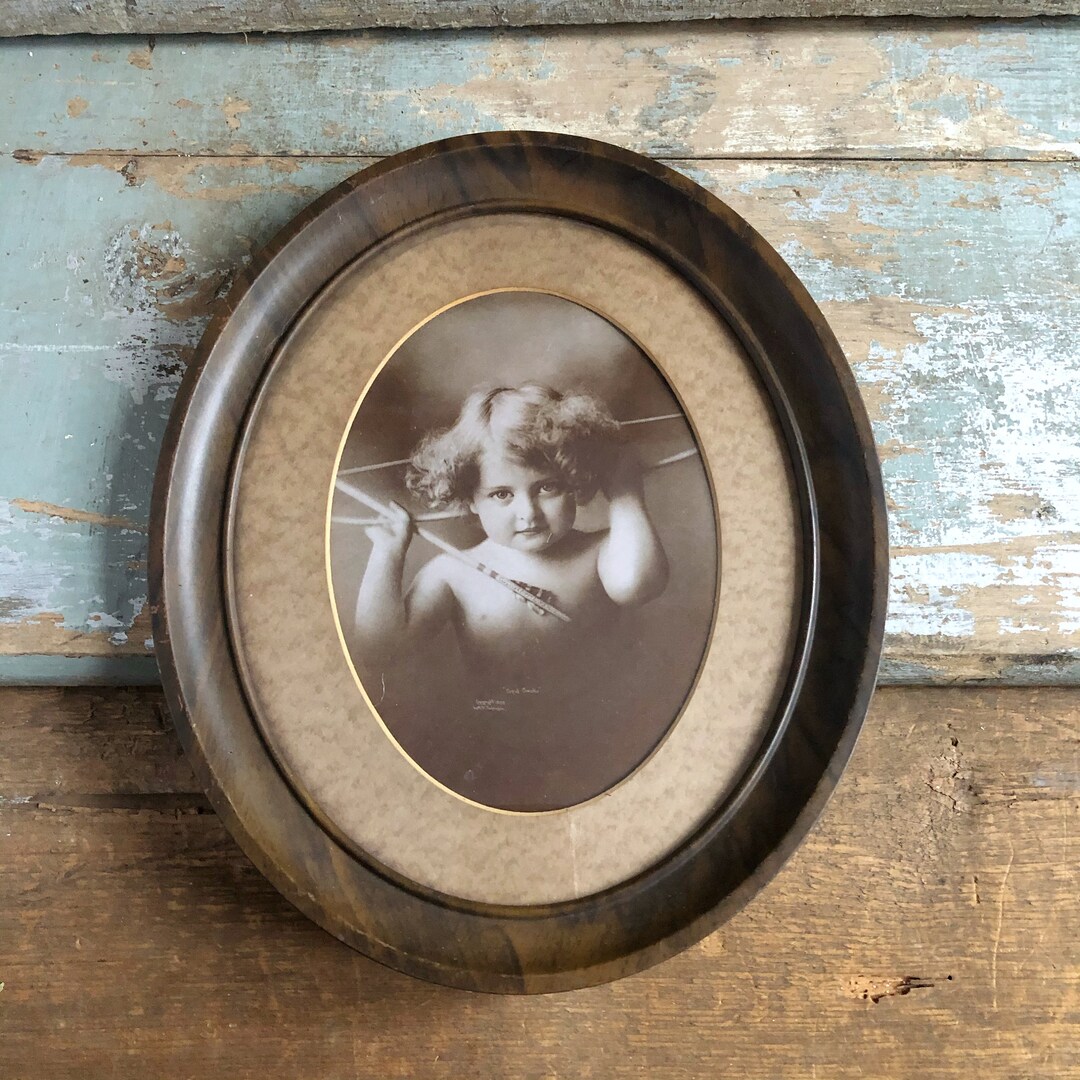 Vintage Artwork Framed in Oval Frame With Matte Cupid Child With Arrow