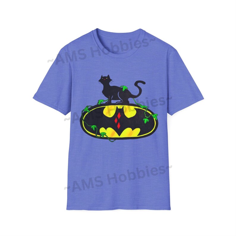 May include: A light blue t-shirt with a black cat sitting on a yellow Batman logo with green vines. The logo has a red diamond in the center.