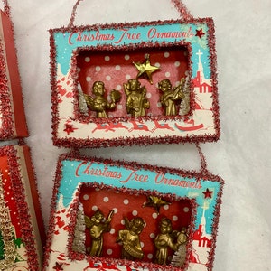 May include: Two vintage Christmas tree ornaments with a red and white polka dot background. Each ornament features a scene with gold angels playing instruments and a star. The ornaments are framed with a red and white border and have the text "Christmas Tree Ornaments" printed on the front.