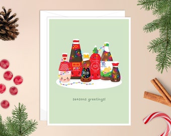 May include: A Christmas card featuring a group of cartoon Asian sauces with festive lights. The sauces include soy sauce, oyster sauce, chili sauce, fish sauce, and sesame oil. The card reads "Seasons Greetings!"