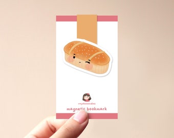 May include: A cute cartoon bread with a smiling face, a magnetic bookmark with the text "raychoostudios magnetic bookmark".