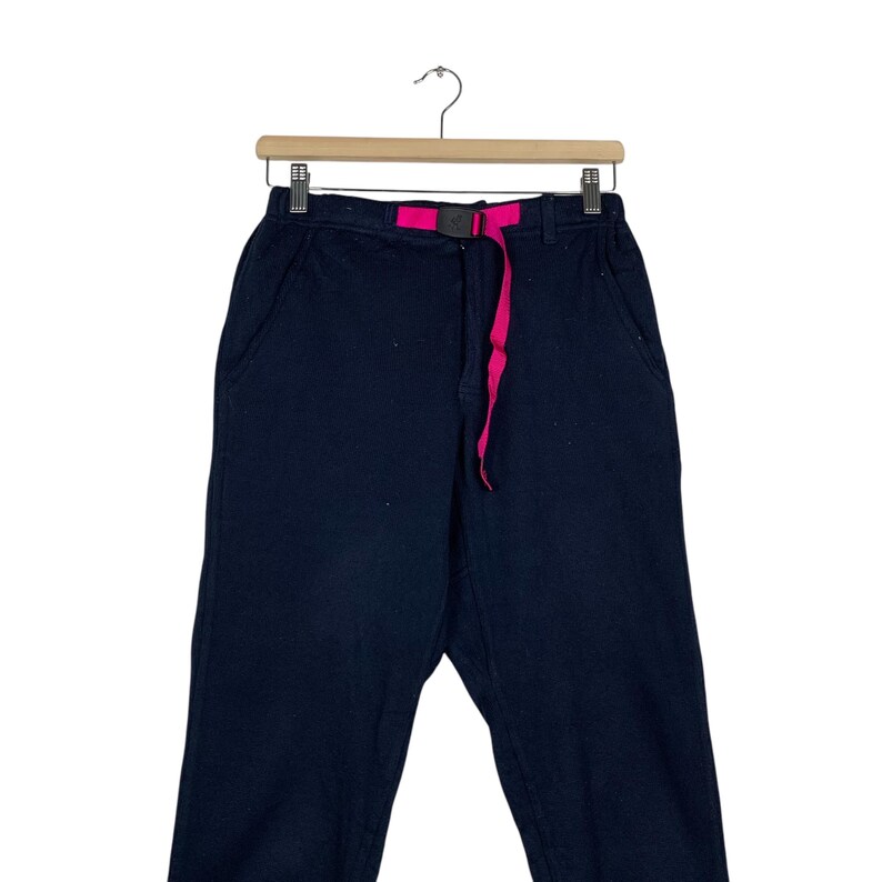 May include: Black pants with a pink drawstring waist.