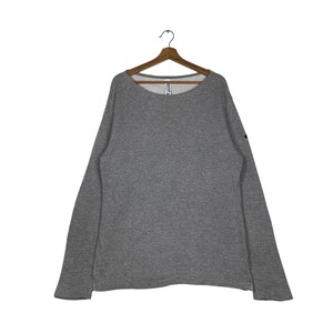May include: A gray long-sleeved sweatshirt with a round neckline.