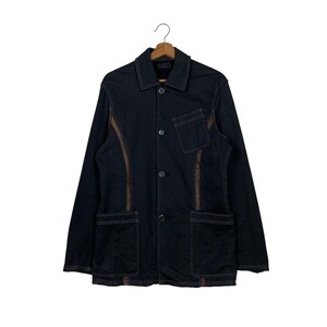 May include: A black denim jacket with brown stitching detail. The jacket has a button-up front, two pockets, and a collar.