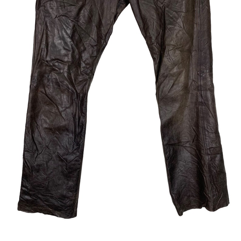 May include: A pair of brown leather pants with a straight leg fit.