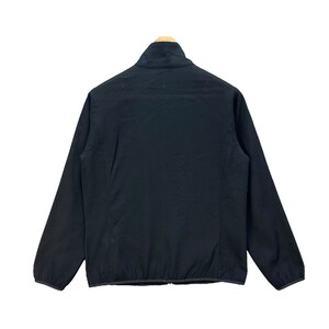May include: A black zippered jacket with a high collar. The jacket is made of a lightweight fabric and has a smooth, matte finish.