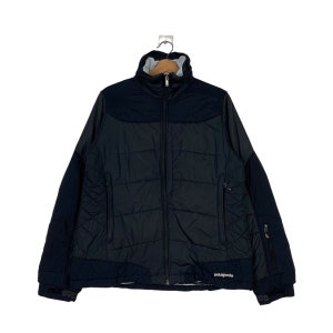 May include: A black quilted jacket with a zip fastening and a Patagonia logo on the bottom right side.