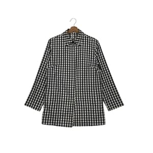 May include: A black and white checkered long-sleeve shirt with a collar and button closure. The shirt is hanging on a wooden hanger against a white background. The checkered pattern is a classic design.