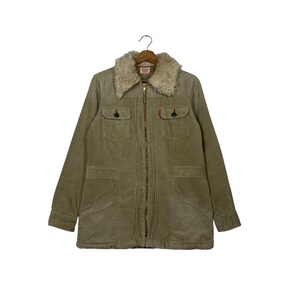 May include: Olive green corduroy jacket with a faux fur collar. The jacket features a zip-up front, two chest pockets, and two lower pockets. The Levi's brand tag is visible on the collar. The jacket has a classic, vintage style.
