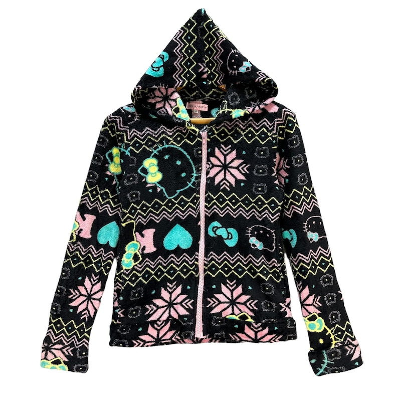 May include: Black fleece zip-up hoodie with a pink, green, and yellow Hello Kitty pattern. The hoodie has a hood with a drawstring and a zipper closure.