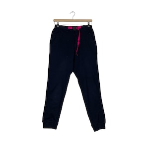 May include: Black sweatpants with a pink drawstring and a black belt.