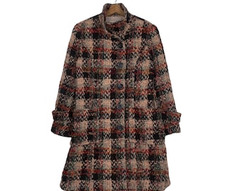 May include: A long-sleeved, plaid coat with a high collar and button closure. The coat is made of a thick, woven fabric and has a relaxed fit.