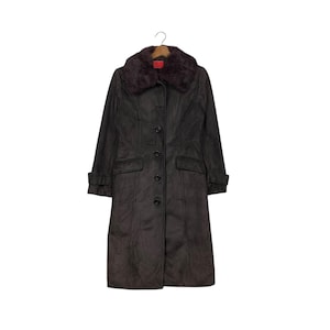 May include: A long brown suede coat with a faux fur collar. The coat has a button closure and two front pockets.