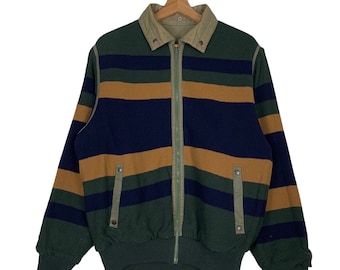 May include: A striped bomber jacket with a zipper closure. The jacket is green, blue, and brown with a contrasting beige collar.