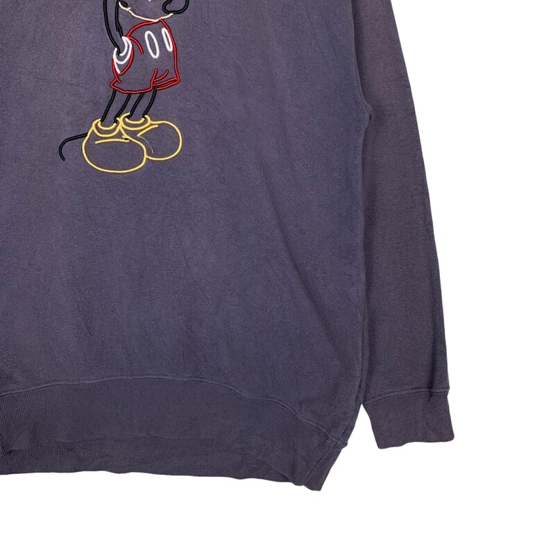 May include: A dark gray sweatshirt with a vintage-style embroidered image of Mickey Mouse in the center. The embroidery is in red, white, black, and yellow.