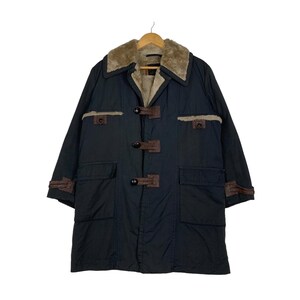 May include: A dark blue long coat with a brown faux fur collar and brown leather accents. The coat has a toggle closure and two large pockets.