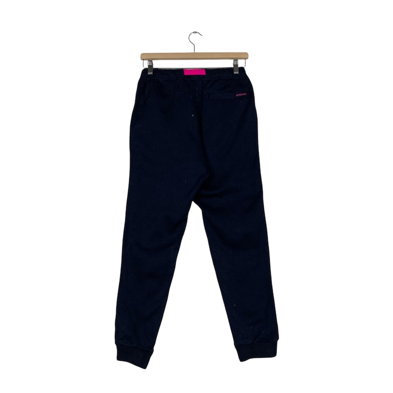 May include: Black sweatpants with a pink drawstring and a small logo on the back pocket.