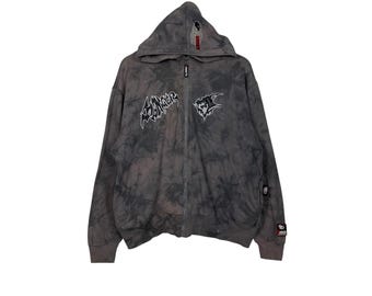 May include: A gray tie-dye zip-up hoodie with a black and white graphic of the word "Slaughter" on the front. The hoodie has a hood with a drawstring and a zipper closure.