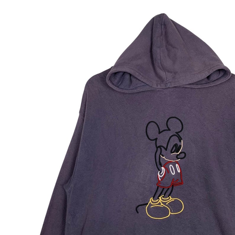 May include: A purple hooded sweatshirt with a black and yellow outline of Mickey Mouse wearing red shorts.