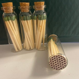 Glass jar w/ 15 matches and striker