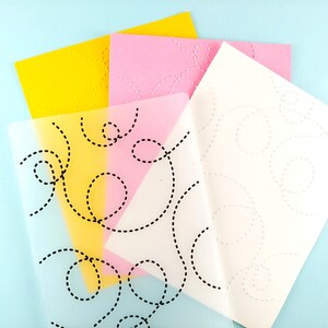 May include: Four sheets of paper with different colored backgrounds and a black dashed line pattern. The sheets are layered on top of each other, with the top sheet being white, the next sheet being pink, the next sheet being yellow, and the bottom sheet being clear.