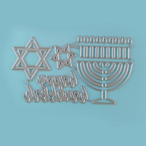 May include: Silver metal die cut design featuring a menorah, two Star of David shapes, and the words "Happy Hanukkah".