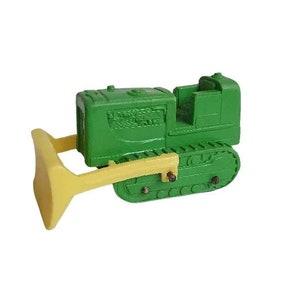 May include: Green toy bulldozer with a yellow blade. The bulldozer has a detailed cab and tracks.