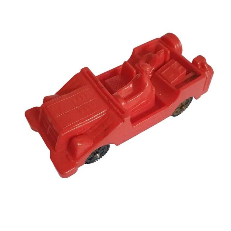 May include: A bright red vintage toy car with black wheels. The toy car has a detailed design, including a driver's seat and a rear storage area. The car is made of plastic and appears to be in good condition.
