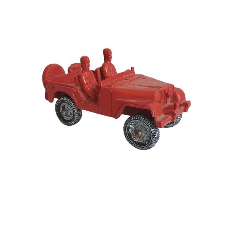 May include: A red toy jeep with two figures in the front seats. The jeep has black tyres and a white steering wheel.
