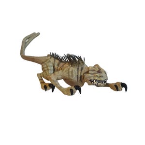 May include: A tan and brown toy dinosaur with sharp claws and teeth. The dinosaur has a long tail and a spiky ridge along its back. The toy is in a running position.
