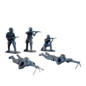 May include: Five grey plastic toy soldiers in various poses, holding rifles. Some are standing, some are kneeling, and one is lying down.