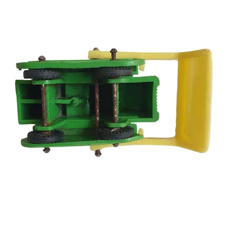 May include: A green and yellow toy tractor with a raised bed. The tractor has four wheels and a yellow handle.