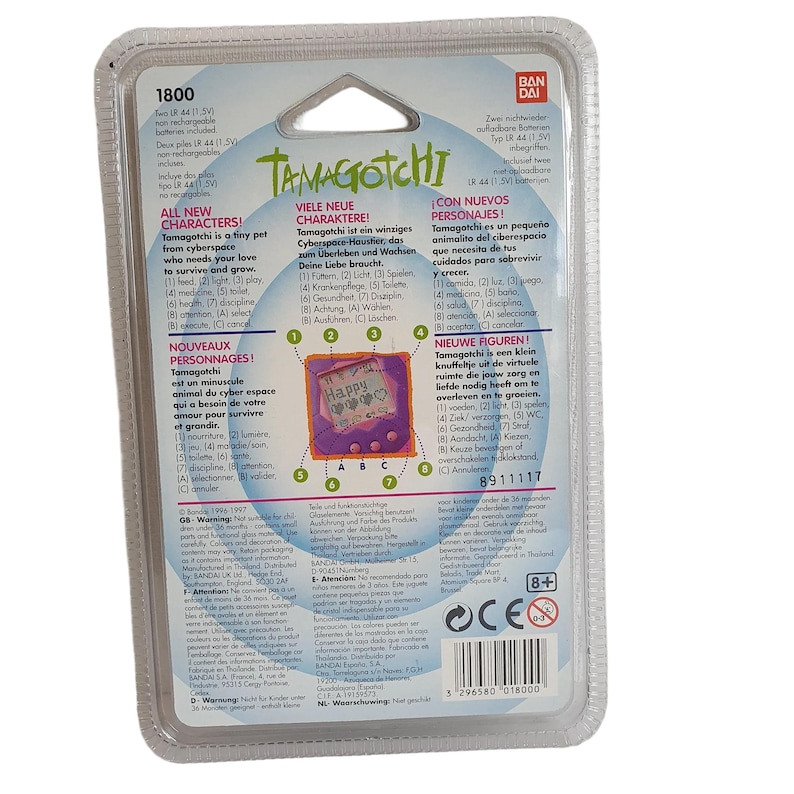May include: Back of a blue, pink, and white Tamagotchi toy packaging. The packaging features a picture of the Tamagotchi toy, which is a small, handheld electronic device with a screen that displays a cartoon character. The packaging also includes text in multiple languages, including English, French, German, Spanish, and Japanese. The text describes the features of the Tamagotchi toy, such as its ability to grow and evolve, and its need for care and attention. The packaging also includes a warning that the toy is not suitable for children under 3 years of age.