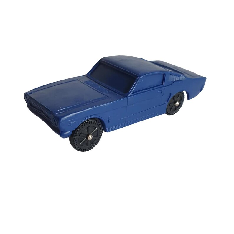 May include: A blue toy car with black wheels. The classic car has a sleek design, featuring a low profile and a detailed front end. The wheels have a realistic tread pattern. The car is a solid blue color.