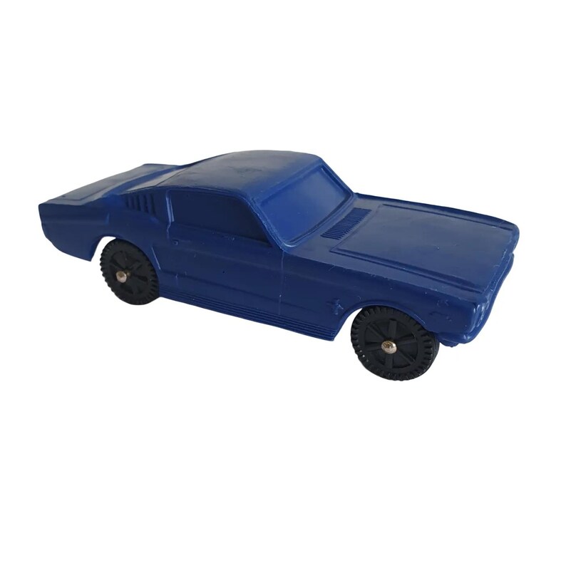 May include: A blue toy car with black wheels. The classic car has a sleek design, featuring a low profile and a detailed front end. The wheels have a textured pattern.